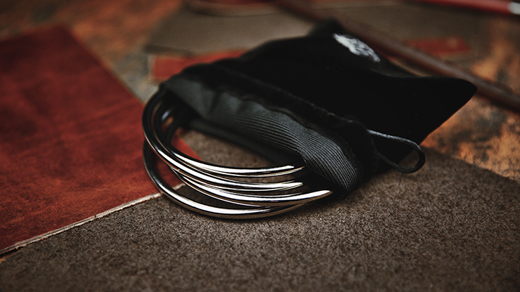 A set of steel linking rings resting on a black velvet bag