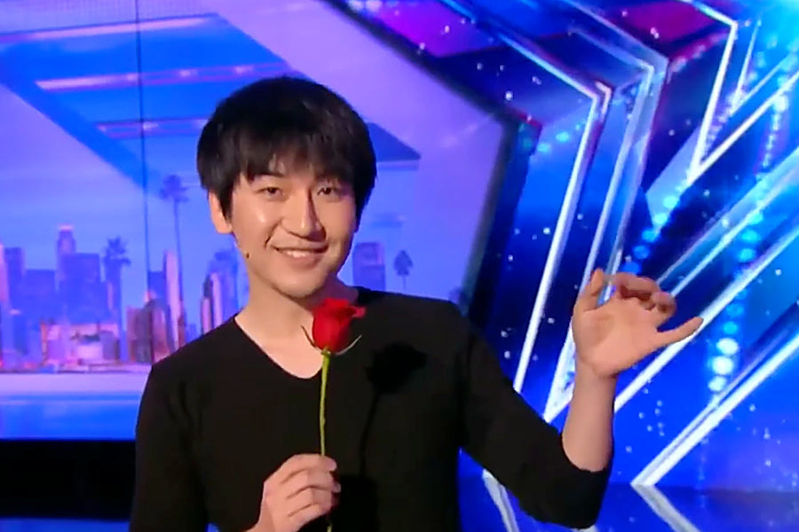 Will Tsai with a rose on the America's Got Talent stage
