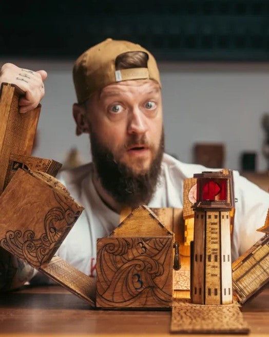 Chris Ramsay with wooden puzzle boxes